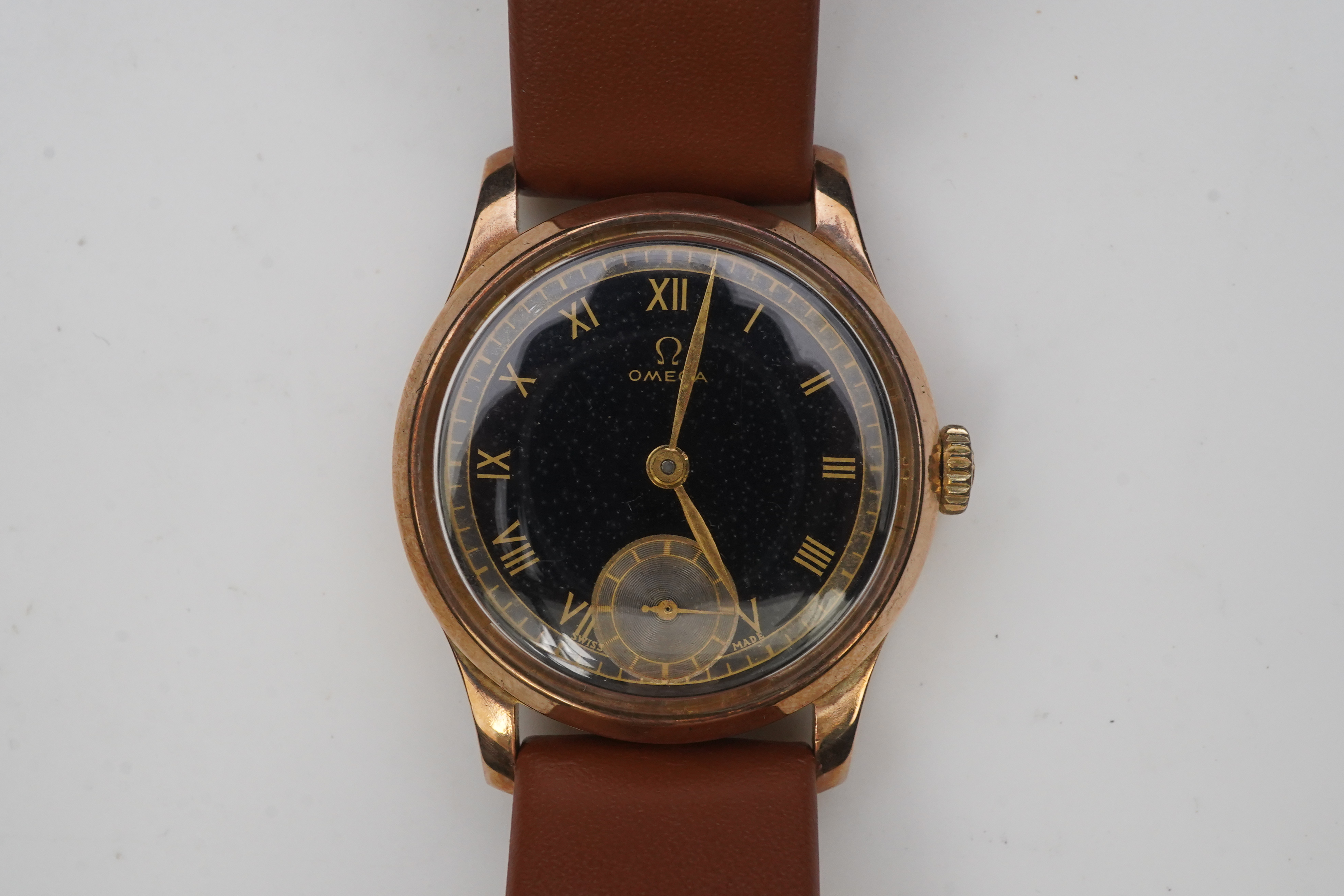 A gentleman's 1940's 9ct gold Omega manual wind wrist watch, on a later associated leather strap